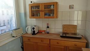 een keuken met een aanrechtblad met een magnetron en een fles wijn bij Sybel in Berlijn