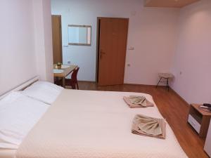 a bedroom with a large bed with two towels on it at Apartment Riki 2 in Ohrid