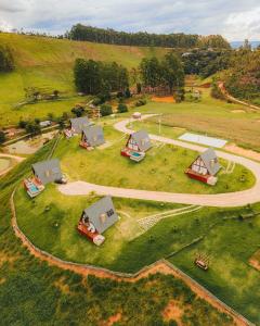 an aerial view of a farm on a hill at Chalés Laguna Alto Viçosa in Venda Nova do Imigrante