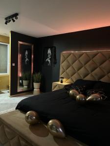 a bedroom with a large bed with a large headboard at La cachette de Georgette in Landrecies
