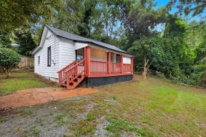 a small house with a red deck on a yard at Little Indale Haus - Near Downtown and Prince Ave in Athens