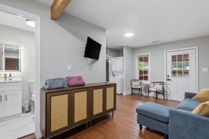 a living room with a couch and a tv at Little Indale Haus - Near Downtown and Prince Ave in Athens