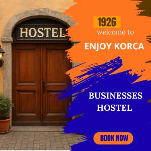 a poster of a wooden house with a door at Business Hostel in Korçë