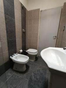 ein Bad mit einem WC, einem Bidet und einem Waschbecken in der Unterkunft Bismark Studio in Marcos Juárez