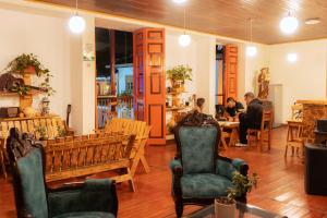 a man and a woman sitting at a table in a room at Hotel Colonial Abejorral in Abejorral