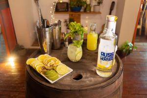 a wooden table with a bottle of juice and lemons at Hotel Colonial Abejorral in Abejorral