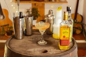 a table with a drink and two bottles of alcohol at Hotel Colonial Abejorral in Abejorral