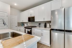 a kitchen with white cabinets and a stainless steel refrigerator at Near Hospitals Home with Pool Access in Temecula in Linda Rose