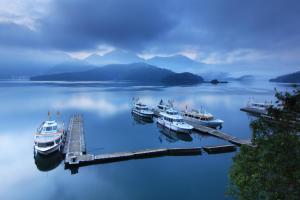a group of boats docked at a dock in the water at Dahan Homestay in Yuchi