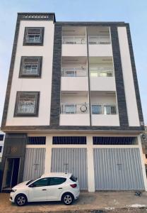 a white car parked in front of a building at Résidence Atlantic in Agadir