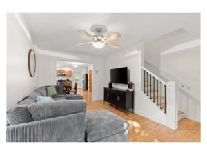 a living room with a couch and a ceiling fan at New listing! The Terra Cotta Bungalow with Firepit in Athens