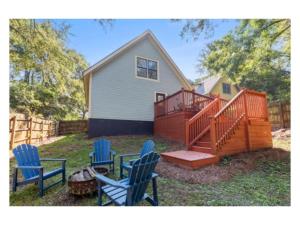 a yard with three blue chairs and a house at New listing! The Terra Cotta Bungalow with Firepit in Athens