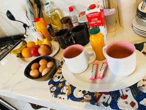 two cups of coffee on a counter with fruits and juice at Balcón de Barcena in Volcán +28 photos