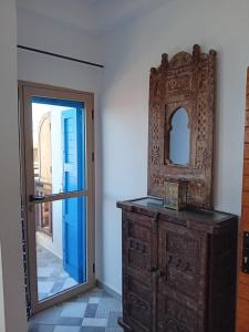 a mirror on top of a dresser next to a door at Villa Azzurra in Imsouane +45 photos