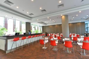 a restaurant with red chairs and tables and a bar at Hotel Chancellor@Orchard in Singapore +21 photos