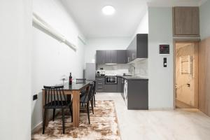 a kitchen with a table and chairs in a room at Serra Modern Apt " Free Parking " Quiet " Near Center in Serres