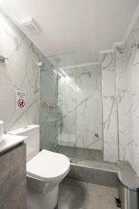 a bathroom with a toilet and a glass shower at Serra Modern Apt " Free Parking " Quiet " Near Center in Serres