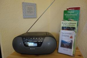 a desk with a computer and a book and a speaker at Anna in Benneckenstein
