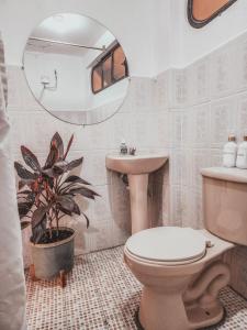 a bathroom with a toilet and a sink and a mirror at Rare Find, Amazing View! Walk to All! in San Pedro La Laguna +24 photos