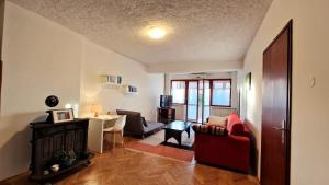 a living room with a red couch and a desk at Poreč Villa Mihaela in Poreč