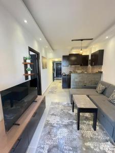 a living room with a couch and a table at Florenza Khamsin Resort in Hurghada