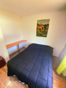 a bedroom with a blue bed in a room at Casa el sueño de Alicia in Villa del Dique