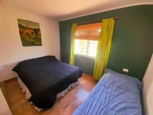 a bedroom with a bed and a window at Casa el sueño de Alicia in Villa del Dique +18 photos