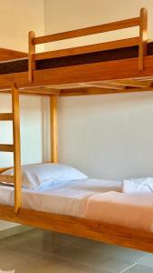 Postel nebo postele na pokoji v ubytování Suíte Florença + 4 fotografie