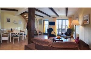 a living room with a couch and a table at Ferienhaus In Neuenkirchen Mit Terrasse in Neuenkirchen +32 photos