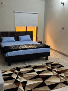 a bedroom with a bed and a rug at Amberwood residency in Islamabad