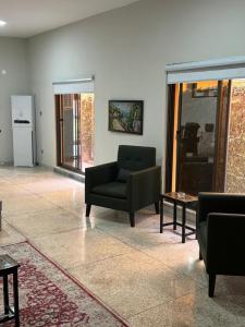 a living room with a couch and a chair at Amberwood residency in Islamabad +18 photos