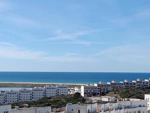 a view of a city with buildings and the ocean at Dar marhaba in Tangier