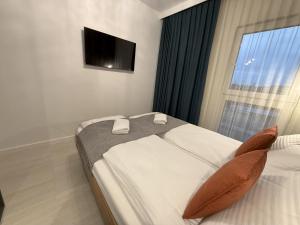 Postel nebo postele na pokoji v ubytování SeaForYou Apartment