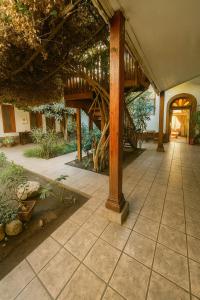 a porch of a house with a wooden structure at Hotel HALLEY & Vive la Magia del Valle de Elqui in Vicuña +9 photos