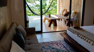 a living room with a couch and a table at Casa Gaya in San Pedro Pochutla +25 photos