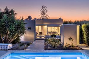 a house with a swimming pool in front of it at Villa Paolo in Noto Marina