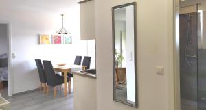 a mirror in a kitchen with a table and a dining room at Appartement In Medenscheid Mit Garten Und Terrasse in Bacharach