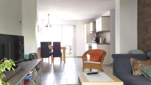 a living room with a couch and a table with chairs at Appartement In Medenscheid Mit Garten Und Terrasse in Bacharach