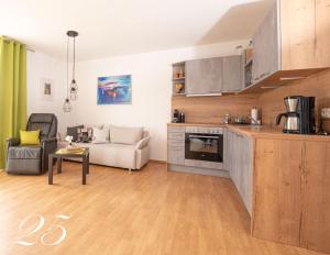 a kitchen and living room with a couch and a table at Appartement Mit Balkon in Bad Koetzting