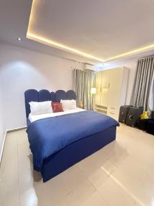 a bedroom with a blue bed in a room at Luxury Apartment in Abuja