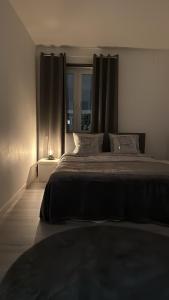 a bedroom with a large bed with a window at Whole 3-room apartment, 10 min from malmo C & 2 min from shops in Malmö