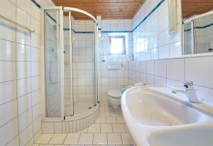 a bathroom with a shower and a sink and a toilet at Holiday Lodge Felix in Saalbach-Hinterglemm