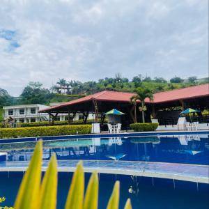 a view of a swimming pool at a resort at Hotel Takuara in Vergara