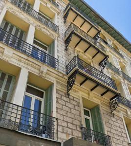 a building with balconies on the side of it at Jolie studio in Nice