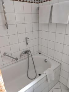 a bathroom with a bath tub with a shower at Dream Apartment in Rötz +2 photos