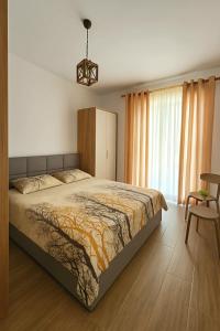 a bedroom with a large bed and a chair at Seaside Bliss in Qerret Beach in Golem