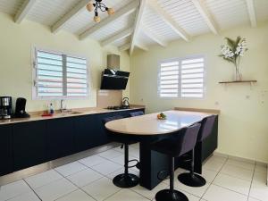 a kitchen with a table and chairs in a room at Ile en Ile in Saint-François +51 photos