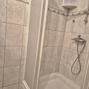 a bathroom with a shower with a shower head at Livno Sympan in Livno