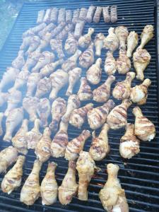 a bunch of chicken and other foods cooking on a grill at Pensiunea Tora in Vatra Dornei +47 photos