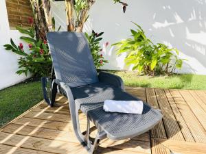 a chair on a deck with a napkin on it at Ile en Ile in Saint-François